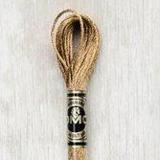 Close up of DMC stranded cotton shade 436 Golden Oak