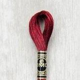 Close up of DMC stranded cotton shade 815 Dark Ruby Red